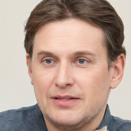 Joyful white adult male with short  brown hair and grey eyes