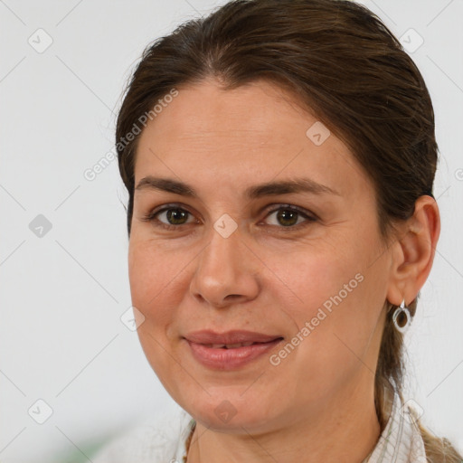 Joyful white adult female with medium  brown hair and brown eyes