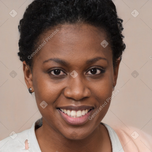 Joyful black young-adult female with short  brown hair and brown eyes