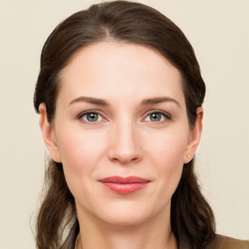 Joyful white young-adult female with long  brown hair and brown eyes