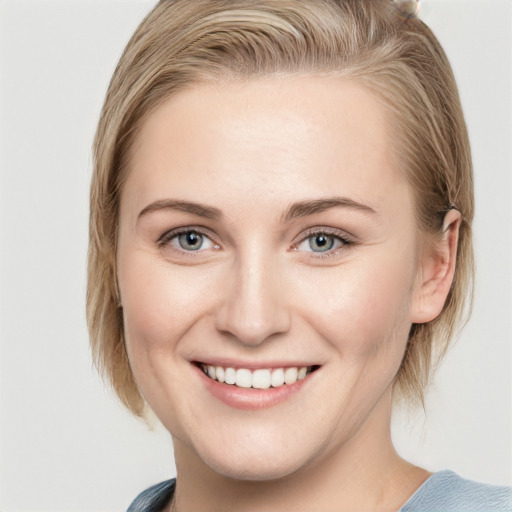 Joyful white young-adult female with medium  brown hair and blue eyes