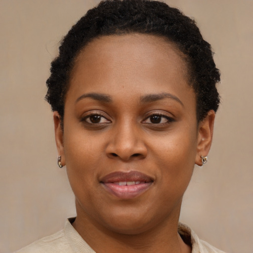 Joyful black young-adult female with short  brown hair and brown eyes