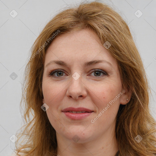 Joyful white adult female with long  brown hair and brown eyes