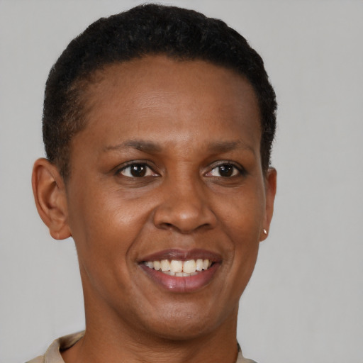 Joyful black young-adult female with short  brown hair and brown eyes