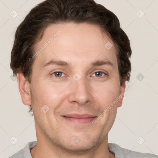 Joyful white adult male with short  brown hair and grey eyes