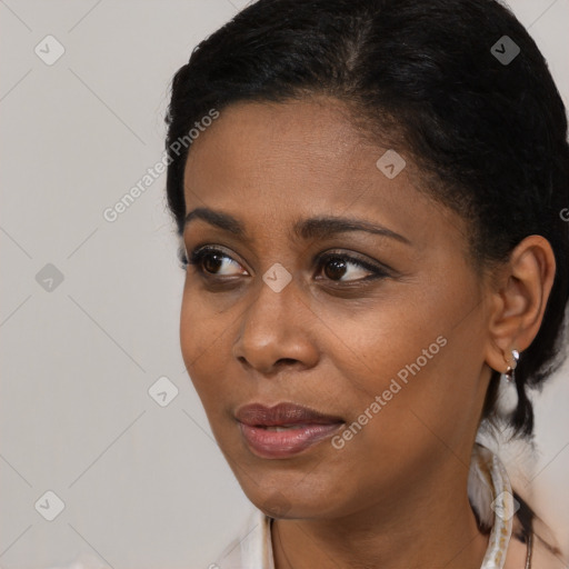 Joyful black young-adult female with short  black hair and brown eyes