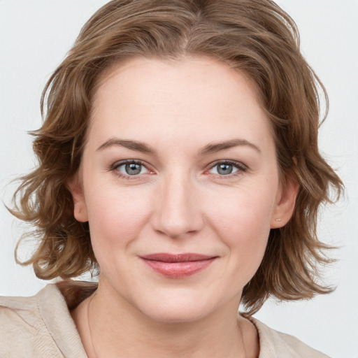 Joyful white young-adult female with medium  brown hair and blue eyes