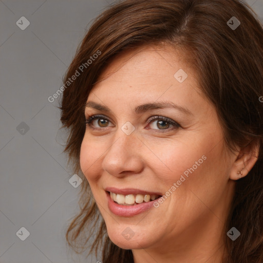 Joyful white adult female with long  brown hair and brown eyes