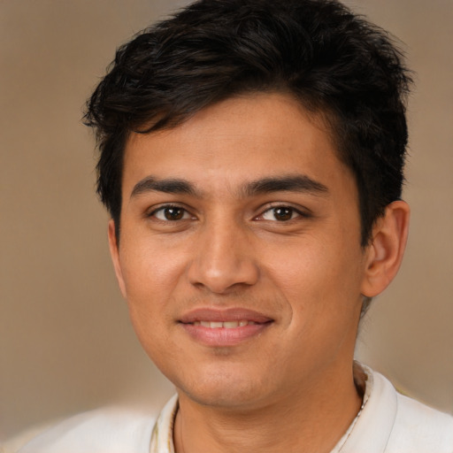 Joyful latino young-adult male with short  brown hair and brown eyes