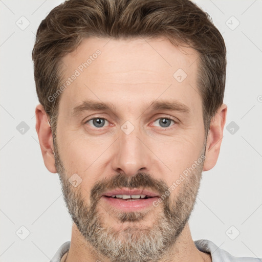 Joyful white adult male with short  brown hair and grey eyes