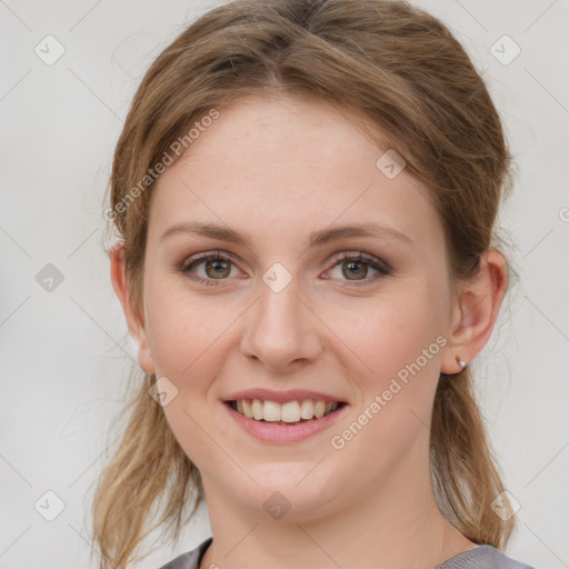 Joyful white young-adult female with medium  brown hair and blue eyes