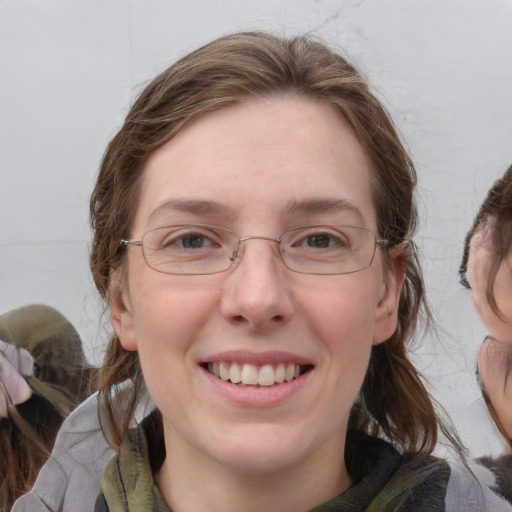 Joyful white adult female with medium  brown hair and blue eyes