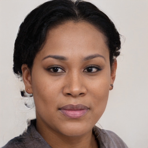 Joyful black young-adult female with short  brown hair and brown eyes