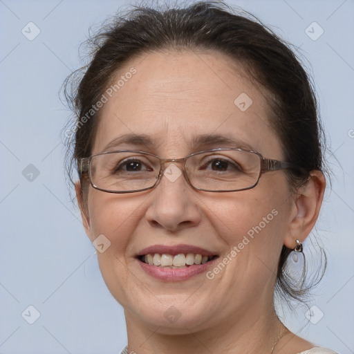 Joyful white adult female with medium  brown hair and brown eyes