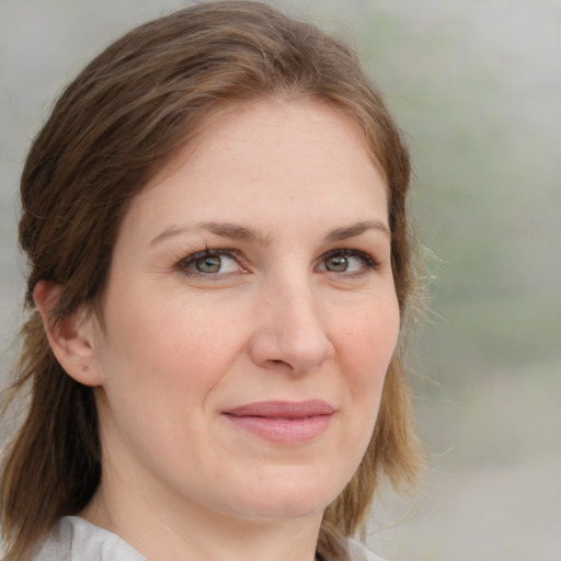 Joyful white young-adult female with medium  brown hair and blue eyes