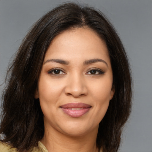 Joyful latino young-adult female with medium  brown hair and brown eyes
