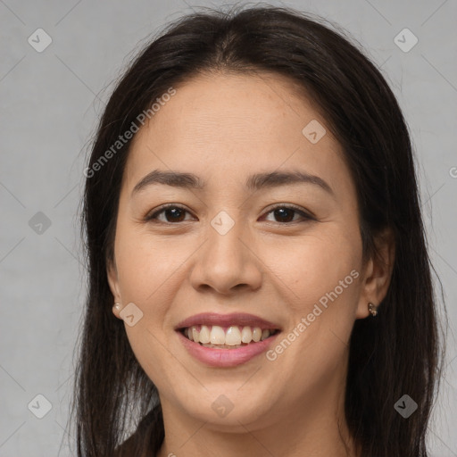 Joyful latino young-adult female with long  brown hair and brown eyes