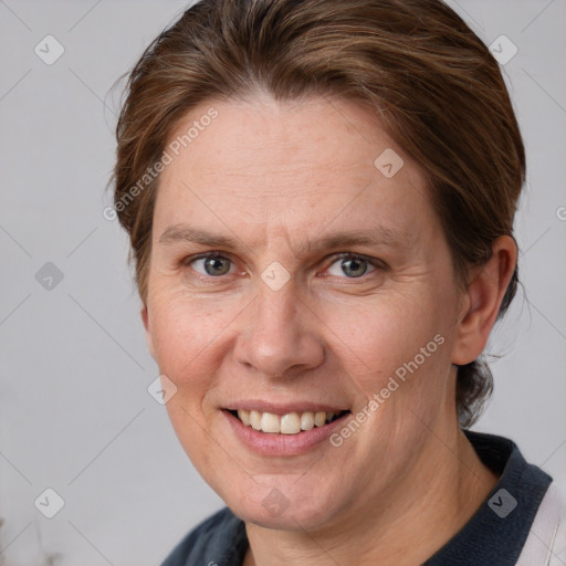 Joyful white adult female with medium  brown hair and grey eyes