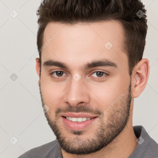 Joyful white young-adult male with short  brown hair and brown eyes