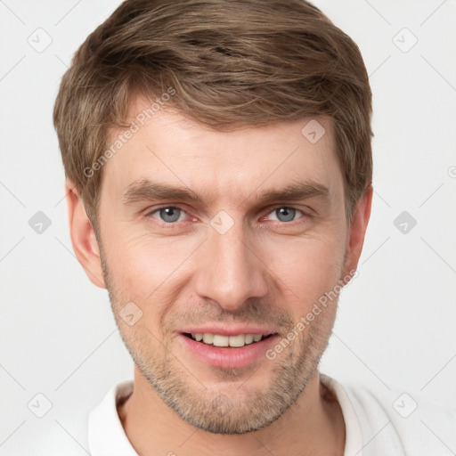 Joyful white young-adult male with short  brown hair and grey eyes