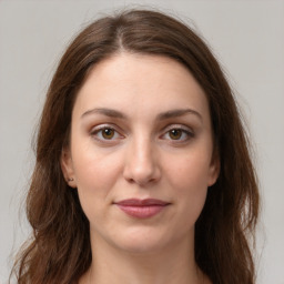 Joyful white young-adult female with long  brown hair and green eyes