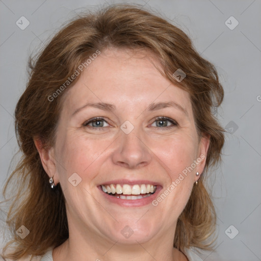 Joyful white adult female with medium  brown hair and blue eyes