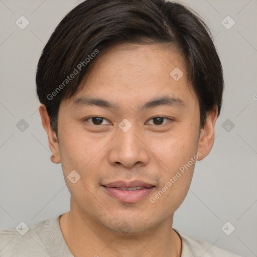 Joyful asian young-adult male with short  brown hair and brown eyes