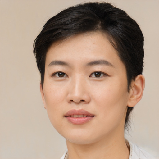 Joyful asian young-adult female with medium  brown hair and brown eyes