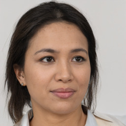 Joyful asian young-adult female with medium  brown hair and brown eyes