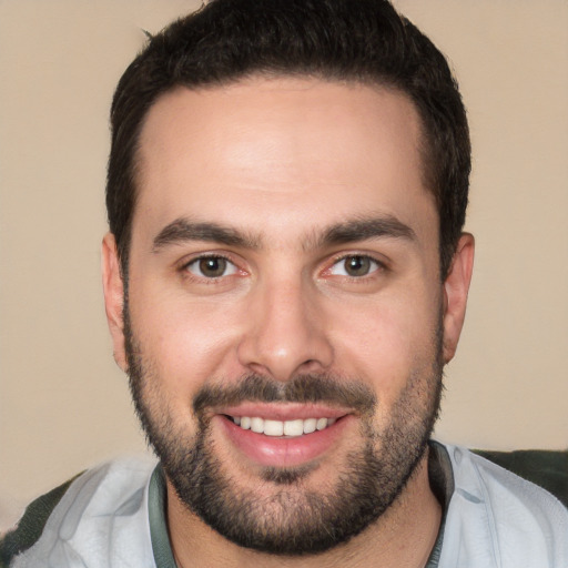 Joyful white young-adult male with short  black hair and brown eyes