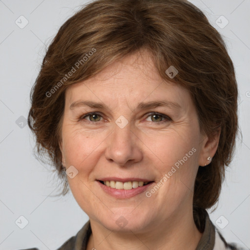 Joyful white adult female with medium  brown hair and grey eyes