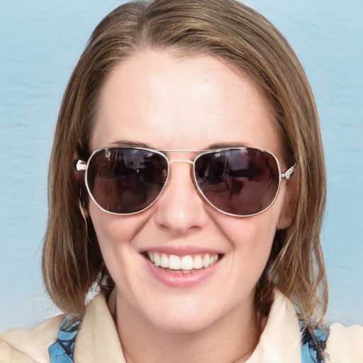 Joyful white young-adult female with medium  brown hair and blue eyes