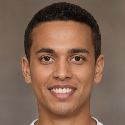 Joyful black young-adult male with short  brown hair and brown eyes