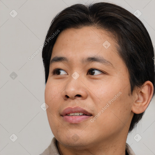 Joyful asian young-adult male with short  brown hair and brown eyes