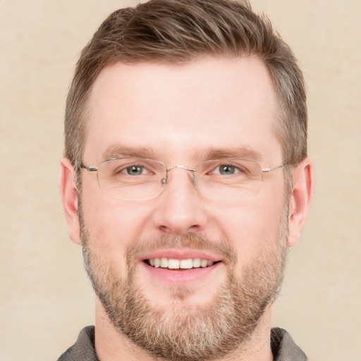 Joyful white adult male with short  brown hair and grey eyes