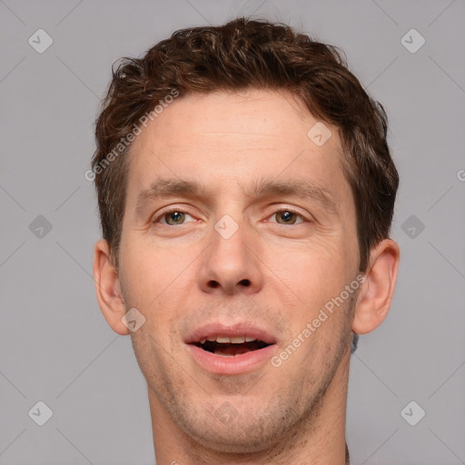 Joyful white adult male with short  brown hair and grey eyes