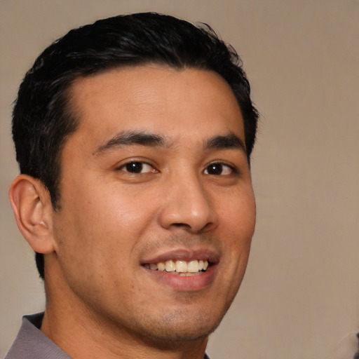 Joyful latino young-adult male with short  brown hair and brown eyes