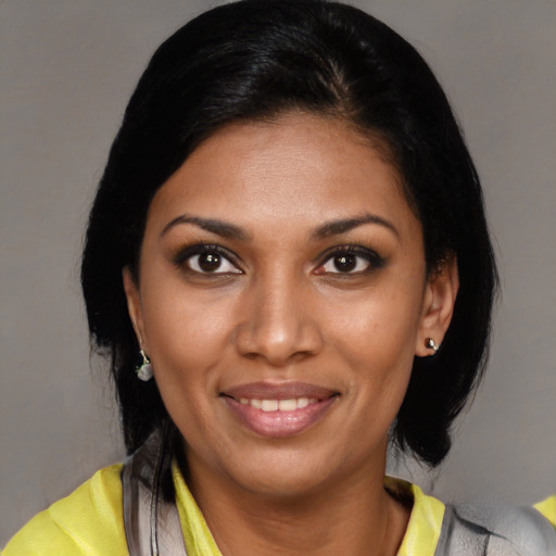 Joyful latino young-adult female with medium  black hair and brown eyes