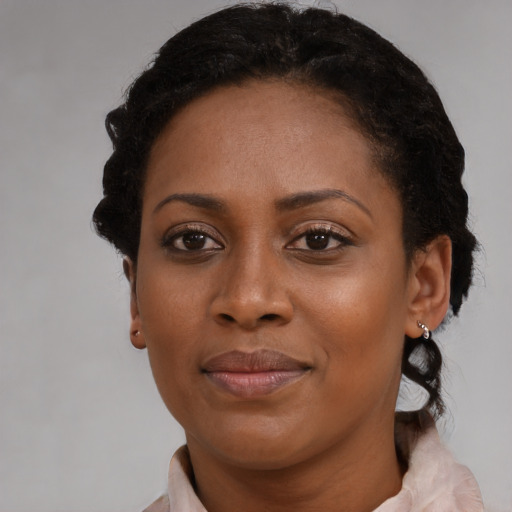 Joyful black young-adult female with medium  brown hair and brown eyes