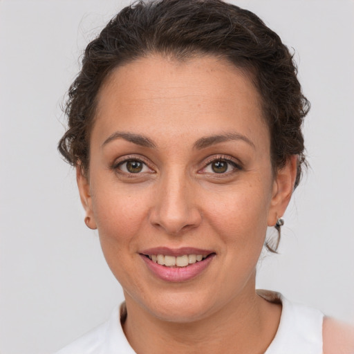 Joyful white adult female with short  brown hair and brown eyes