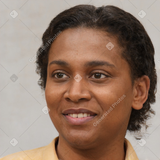 Joyful black young-adult female with short  brown hair and brown eyes