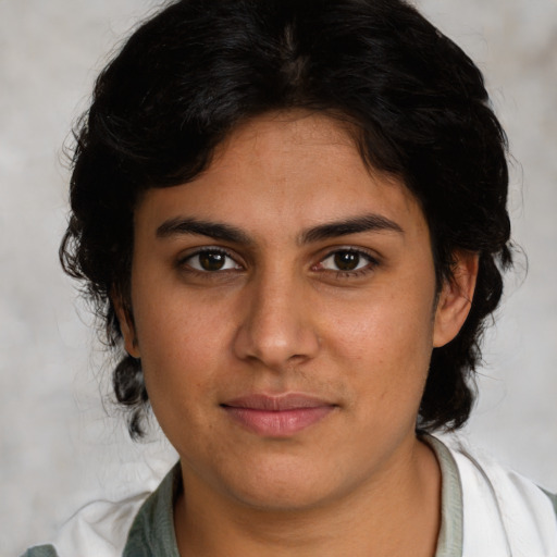Joyful latino young-adult female with medium  brown hair and brown eyes