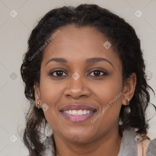 Joyful black young-adult female with long  brown hair and brown eyes