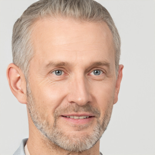 Joyful white middle-aged male with short  gray hair and brown eyes