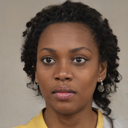 Neutral black young-adult female with medium  brown hair and brown eyes
