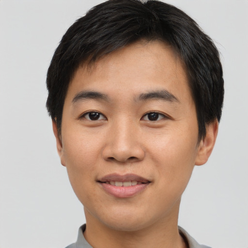 Joyful asian young-adult male with short  black hair and brown eyes