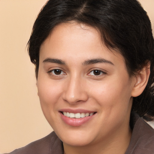 Joyful white young-adult female with medium  brown hair and brown eyes