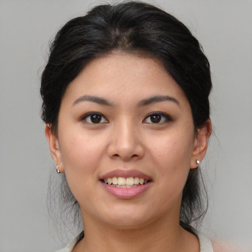 Joyful asian young-adult female with medium  black hair and brown eyes