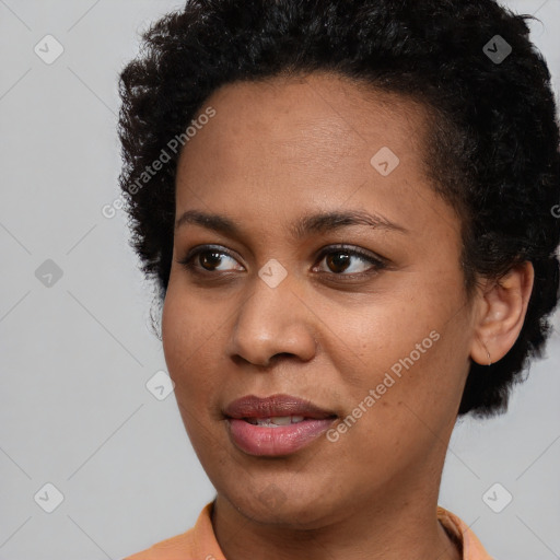 Joyful black young-adult female with short  brown hair and brown eyes