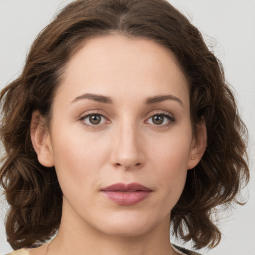 Joyful white young-adult female with medium  brown hair and green eyes